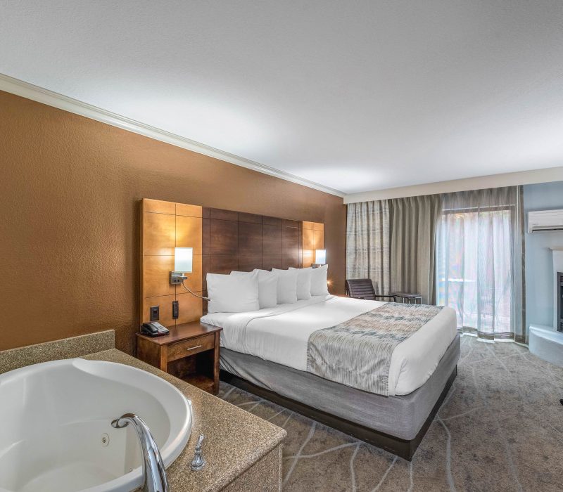 Spacious 1 King Bed Whirlpool Suite with Fireplace at Arroyo Pinion Boutique Hotel featuring a private whirlpool, cozy fireplace, and modern amenities