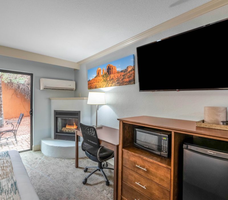 1 King Bed Whirlpool Suite at Arroyo Pinion Boutique Hotel featuring modern amenities including TV, refrigerator, microwave, and private whirlpool for ultimate comfort