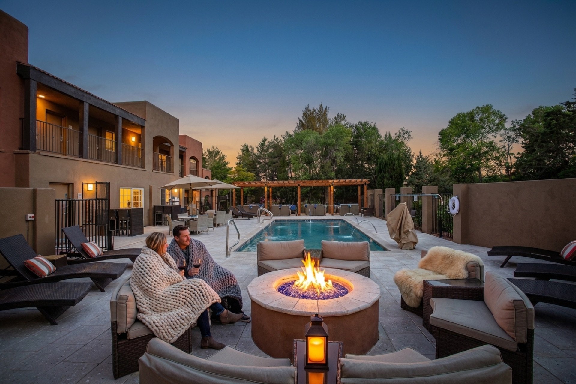 Heated pool and fire pit lounge at dusk