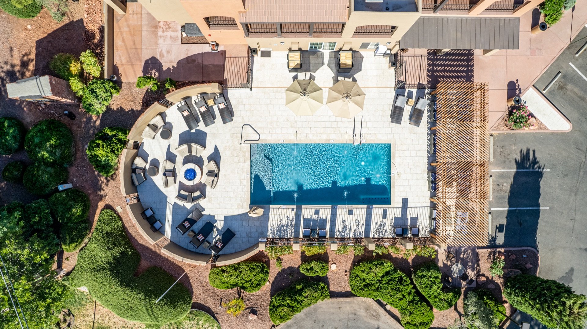 Pool, fire pit lounge, and pergola from above