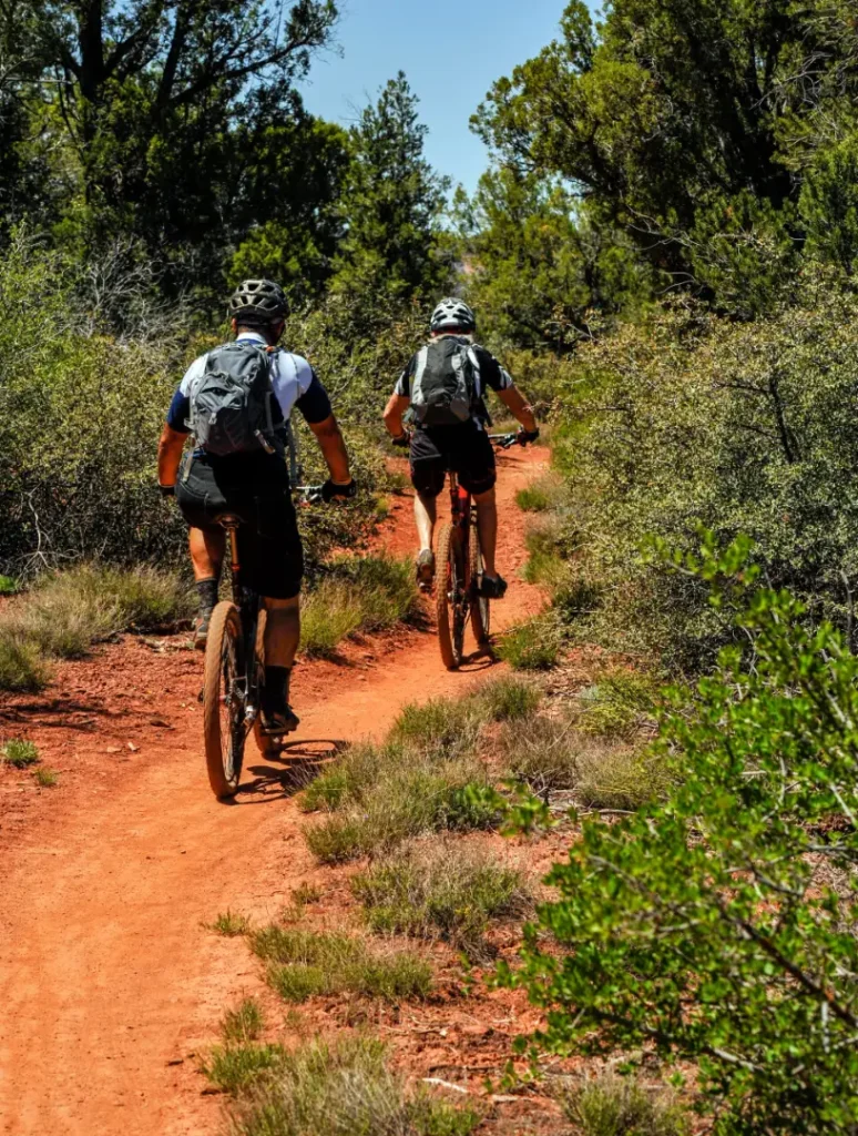 Guest cycling near Arroyo Pinion Boutique Hotel with scenic Sedona red rock trails