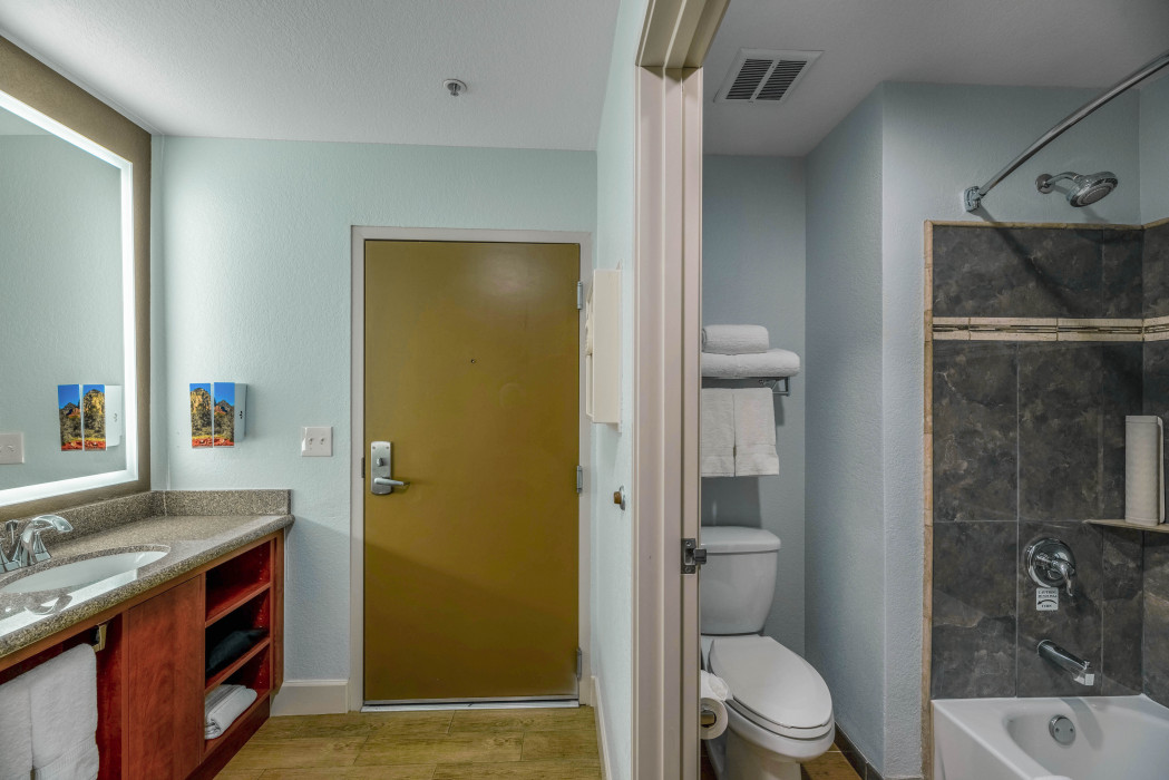 Spacious and modern 1 King Bed bathroom at Arroyo Pinion Boutique Hotel, featuring luxury amenities and stylish design