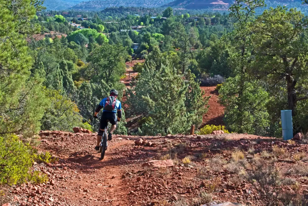 Guest enjoying a cycling adventure in the scenic red rock mountains near Arroyo Pinion Hotel Sedona
