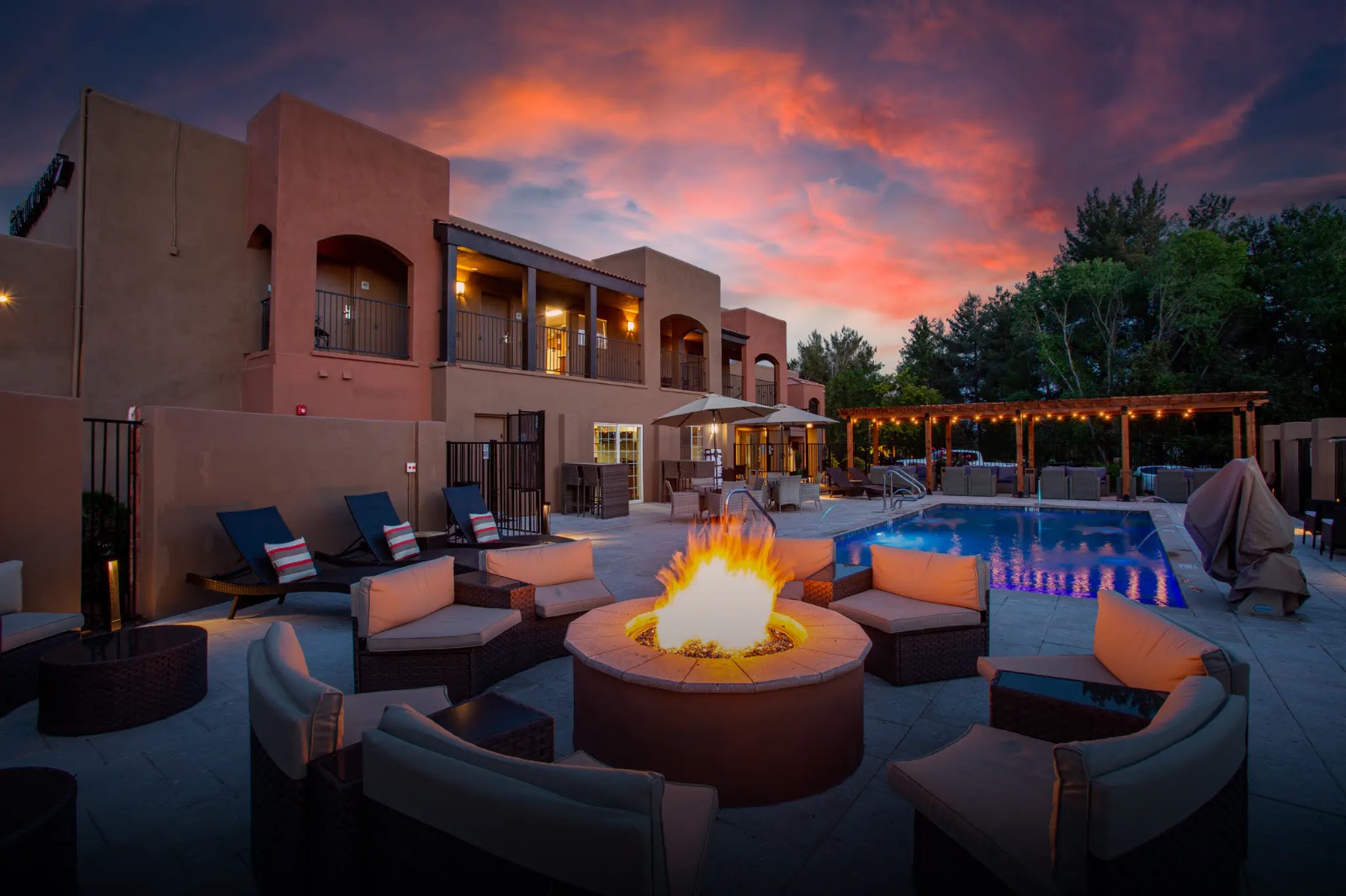 Fire pit and pool at Arroyo Pinion, a Sedona retreat in West Sedona, on a warm evening