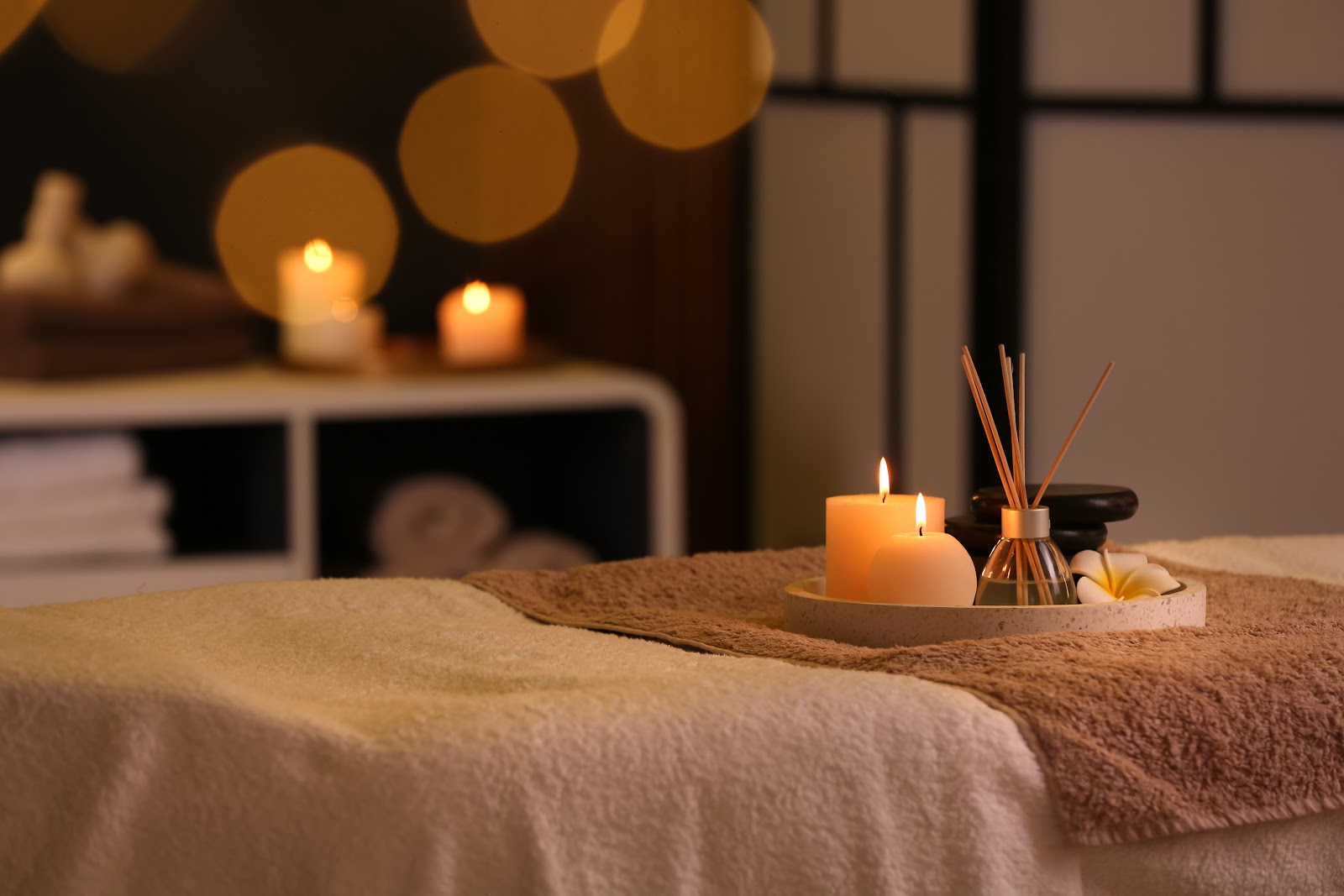 Candles and aromatic reeds in a warm, low-lit Sedona spa treatment room