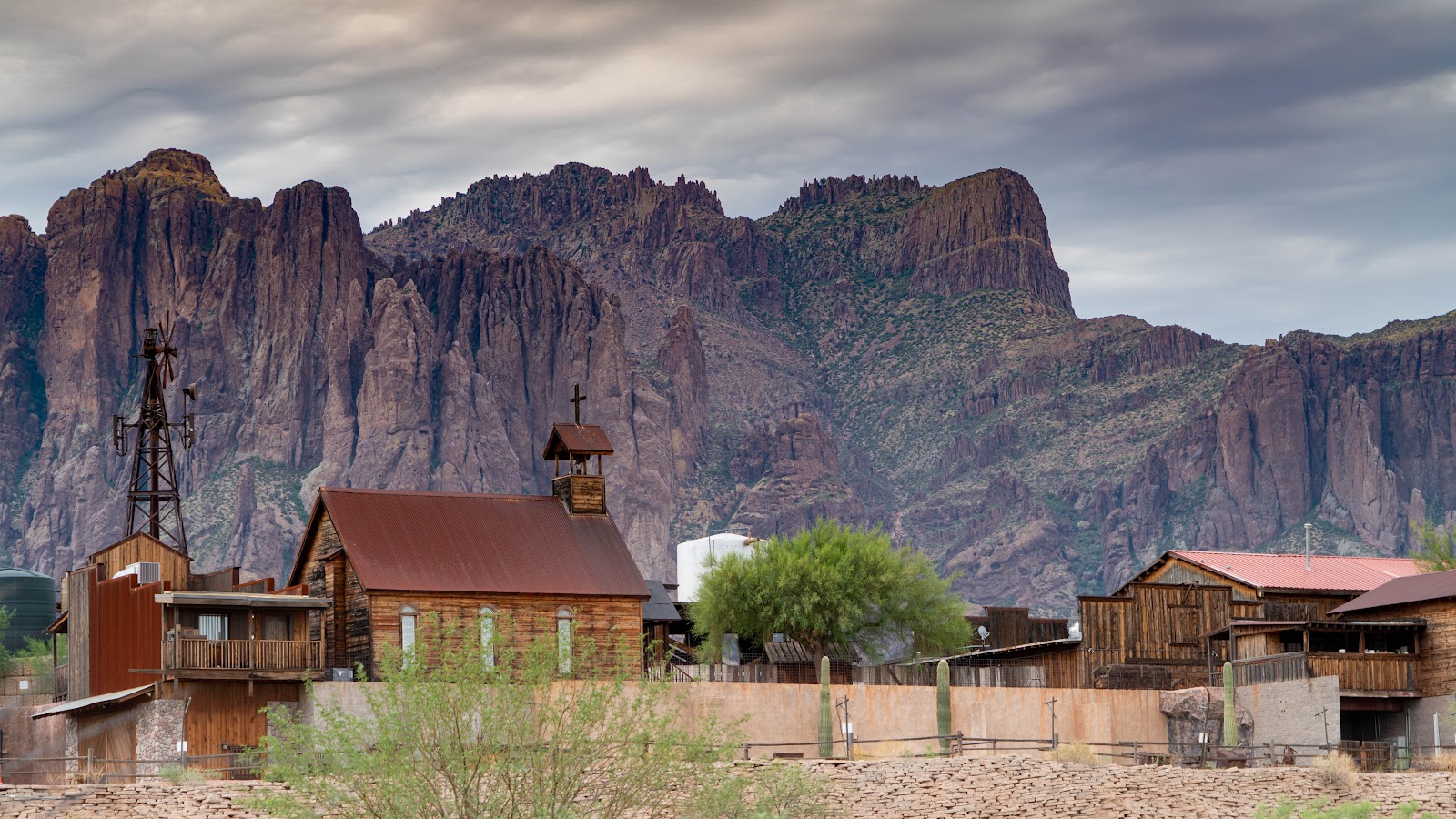 Weathered buildings of an old Arizona ghost town beneath the mountains at dusk, the mood of a Halloween trip to Jerome