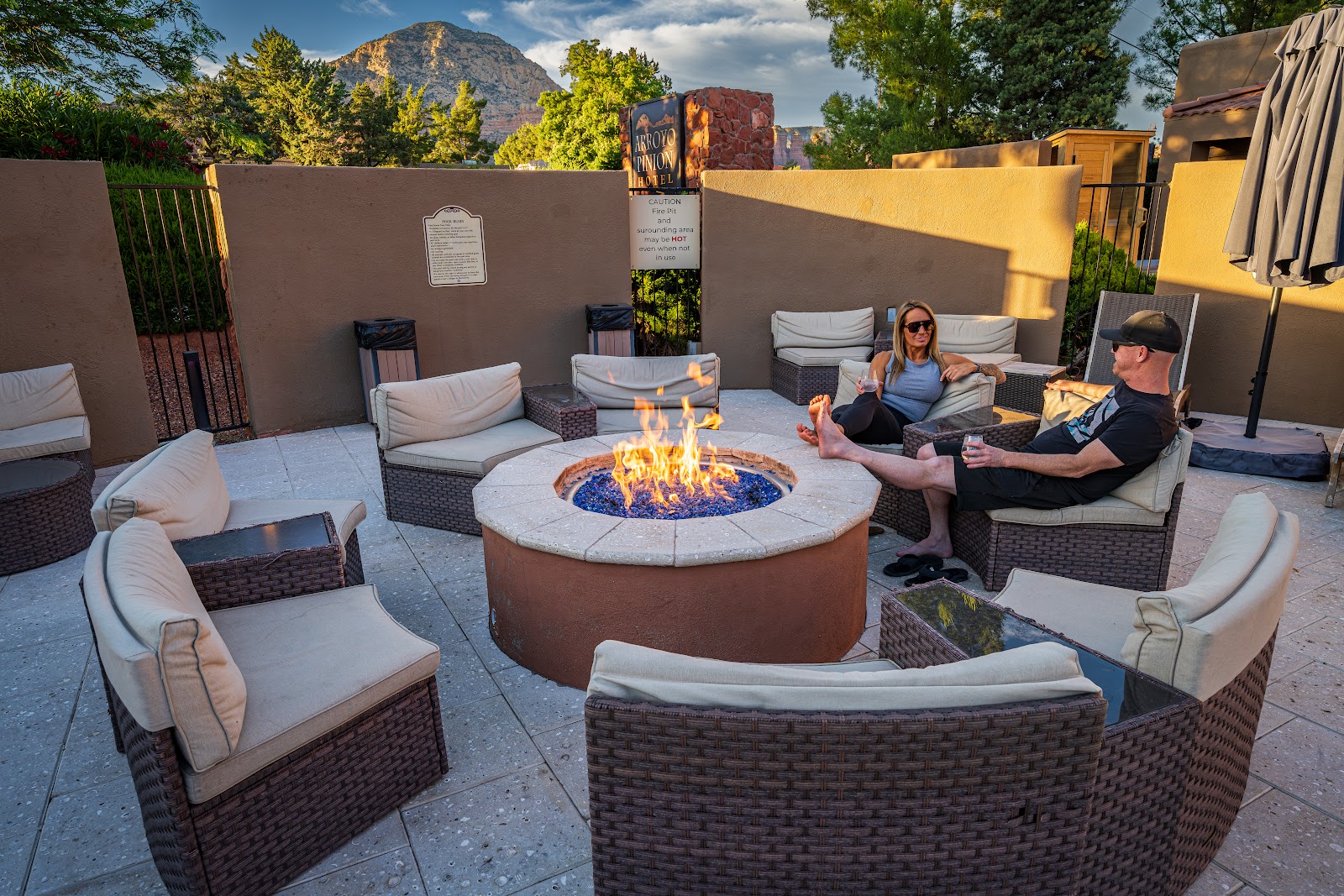 Guests relaxing around the fire pit on the patio at Arroyo Pinion in West Sedona at dusk